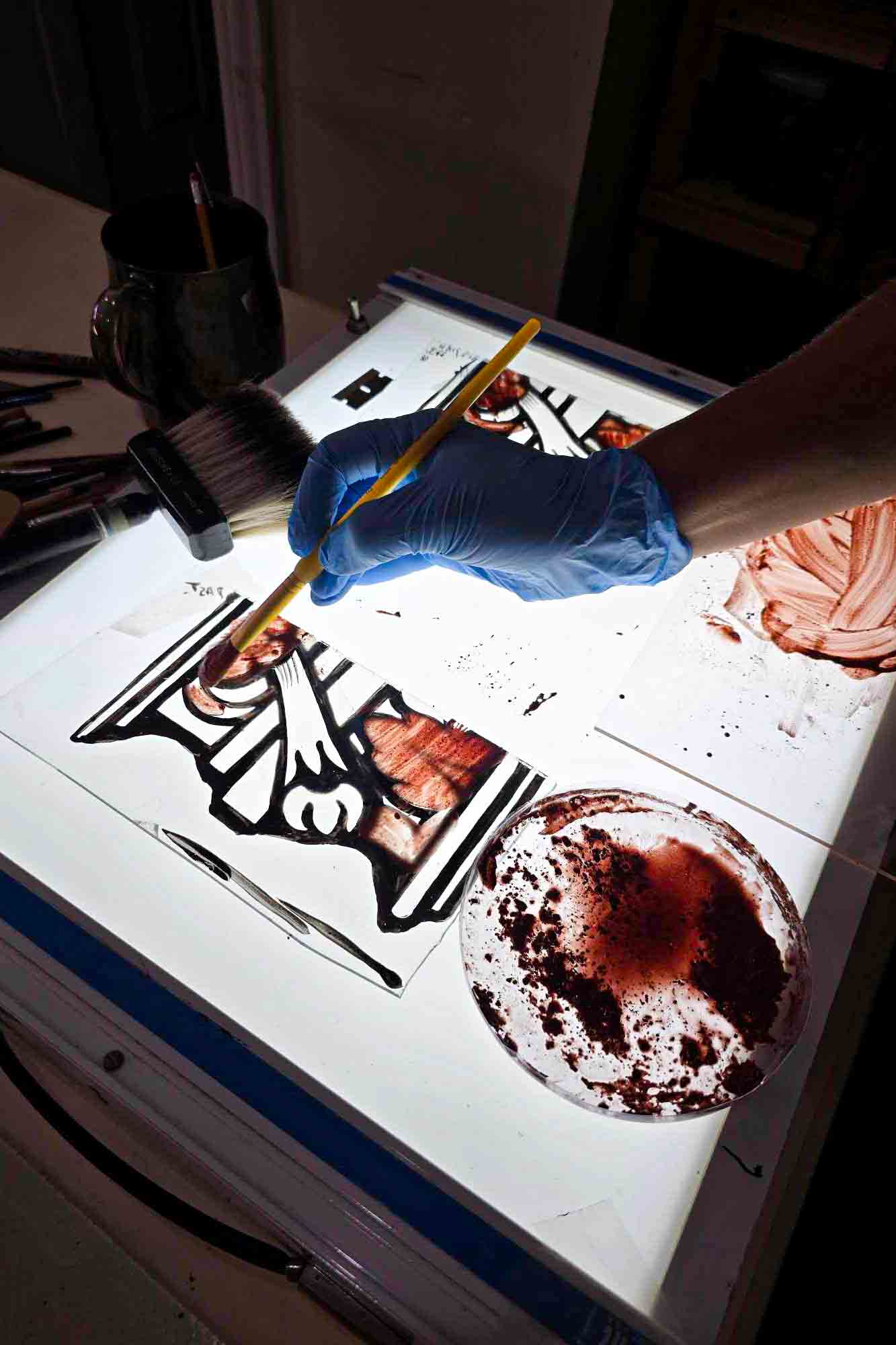 Baltic Art Studio conservator restoring painted glass from a Zettler stained glass window