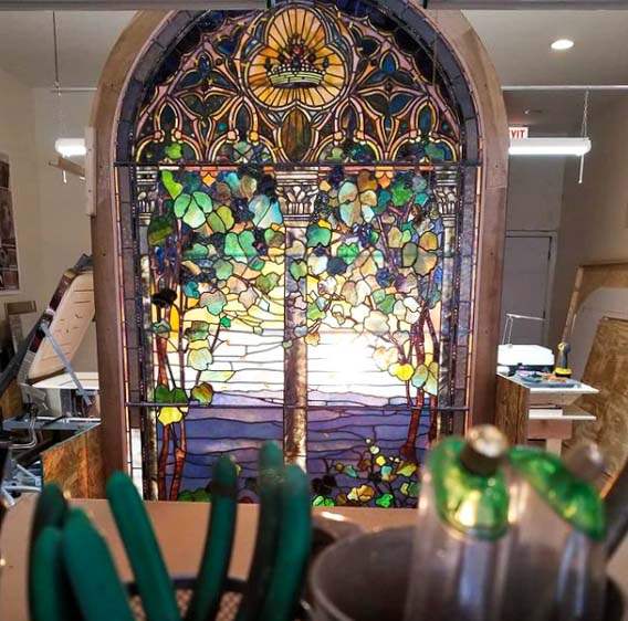 Restored Tiffany Studios stained glass window in Baltic Art Studio workshop