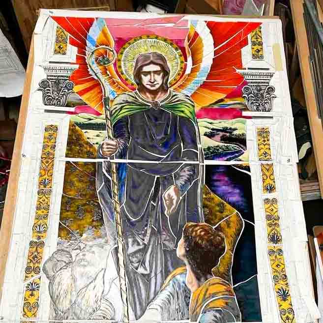 Stained glass artist Mindaugas Vitkauskas beside completed Archangel window at St. John Cantius Church